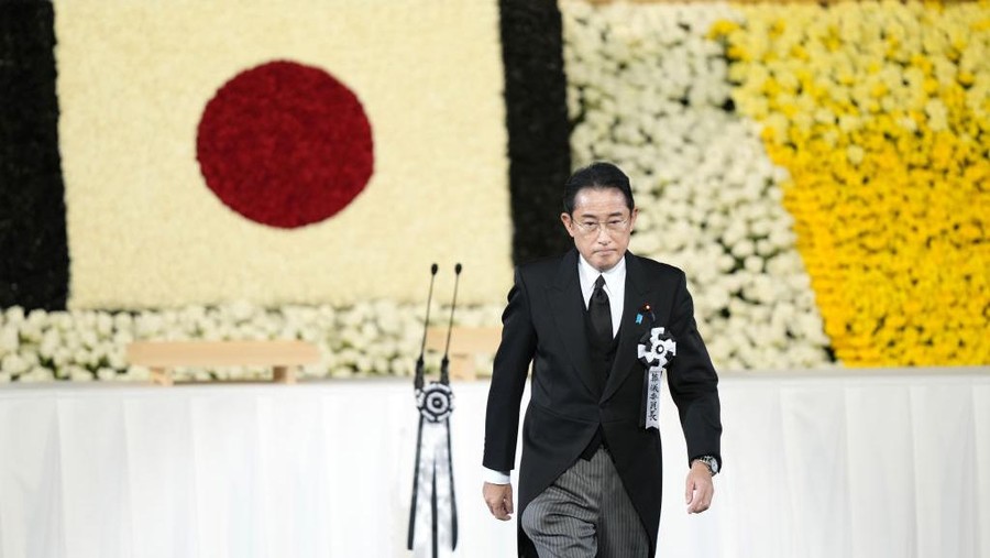 TOKYO, JAPAN - SEPTEMBER 27: Japan’s Prime Minister Fumio Kishida walks on stage during the state funeral for Japan's former prime minister Shinzo Abe on September 27, 2022 at the Budokan in Tokyo, Japan. Several current and former heads of state visited Japan for the state funeral of Abe, who was assassinated in July while campaigning on a street. (Photo by FPool/Getty Images)