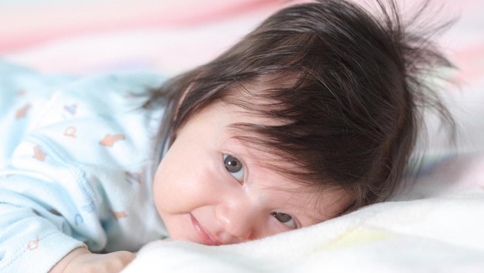 Beautiful baby lying on the bed