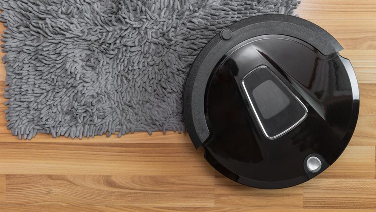 903187132 Robot vacuum cleaner on laminate wood floor with carpet cleaning