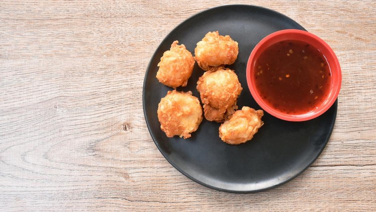 crispy fried squid ball dipping spicy and sweet sauce on plate