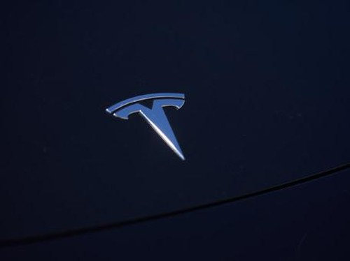 A tesla car charges at a charging station outside a Tesla store in Beijing on April 29, 2022. (Photo by Jade Gao / AFP)