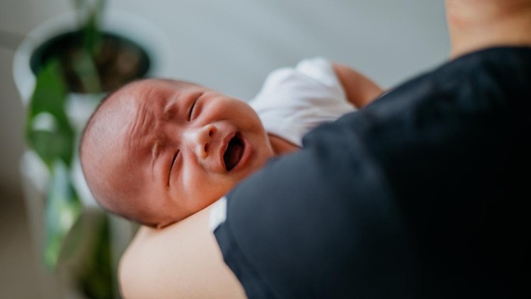 Ilustrasi Penyebab Bayi Baru Lahir Bangun di Tengah Malam Image of an Asian Chinese mother comforts a crying baby