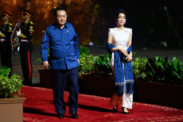 Kim Keon Hee, Ibu negara Korsel kembali mencuri perhatian dengan padanan gaun putih dan detail pada bagian bahu bersama selendang biru yang senada dengan sang suami.Foto: Getty Images/Leon Neal