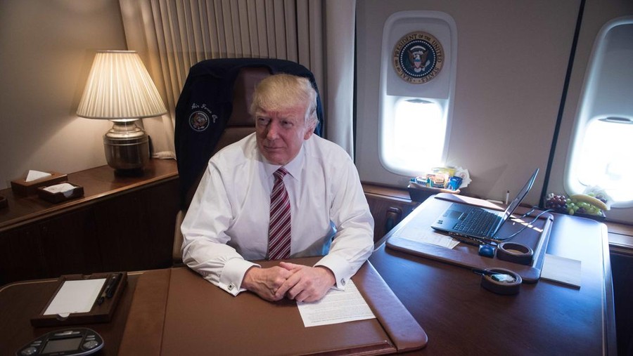 US President Donald Trump poses in his office aboard Air Force One at Andrews Air Force Base in Maryland after he returned from Philadelphia on January 26, 2017.

Donald Trump made his maiden voyage outside the Washington area as US president Thursday, meeting with lawmakers to map out their 2017 policy strategy and smooth emerging differences between the White House and congressional Republicans. / AFP PHOTO / NICHOLAS KAMM        (Photo credit should read NICHOLAS KAMM/AFP via Getty Images)