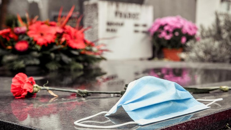 Surgical mask on tombstone. RIP victim of Coronavirus.