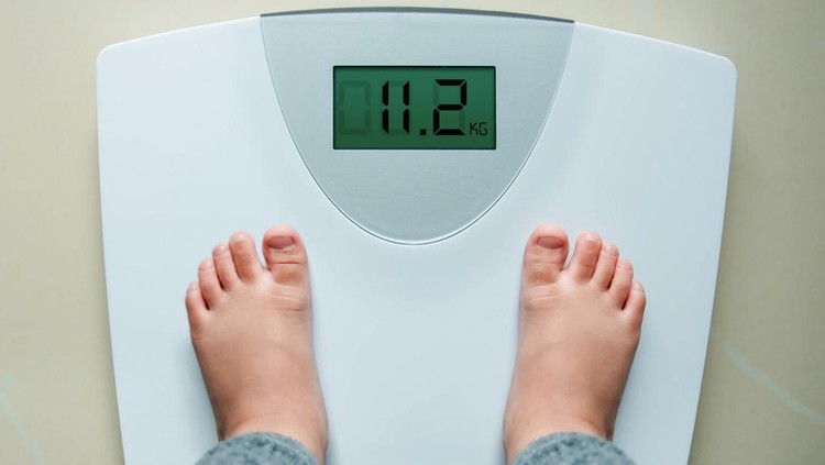 Healthy Weight Gain for Baby or Children Concept, A 2 Years Old Kid Standing on Weight Scales, Top View