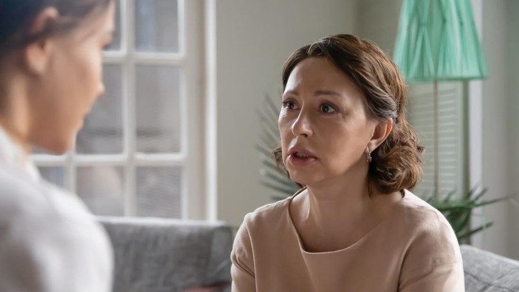 Worrying middle aged senior woman sharing life or health problems or asking for advice professional psychologist or caring grown up daughter at home, trustful sincere family relations concept.