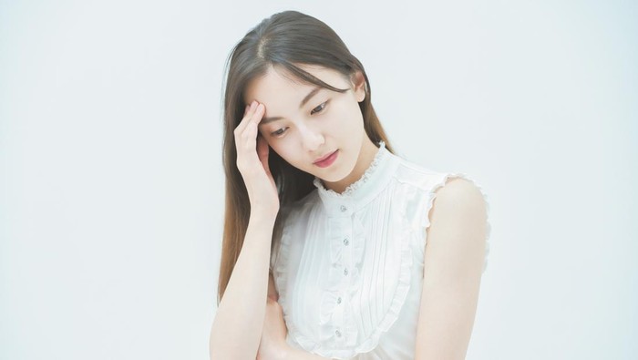 Asian young woman with a stressed look