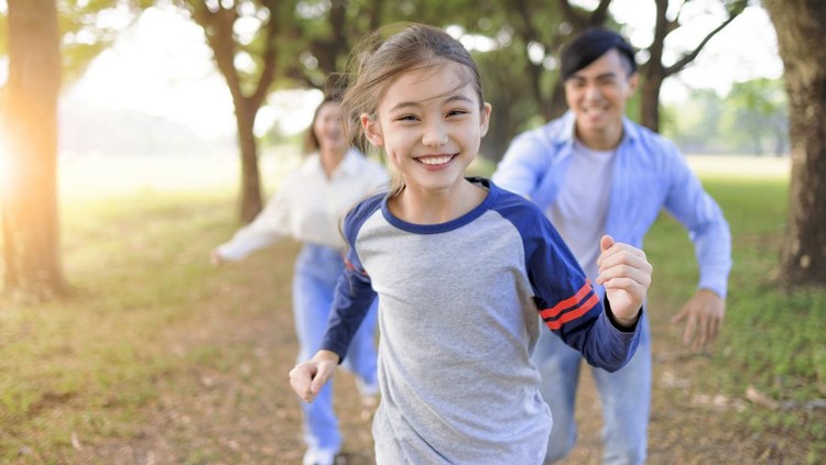 Happy Family  running and playing together in the park