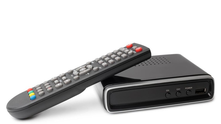 Digital TV tuner with remote control on white background