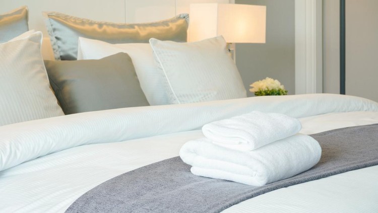 Clean towels on bed at hotel room