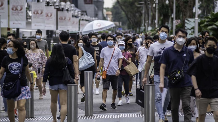 SINGAPORE - 2021/10/02: People wearing face masks as a preventive measure against the spread of covid-19 walk along Orchard Road, the famous shopping district. (Photo by Maverick Asio/SOPA Images/LightRocket via Getty Images)