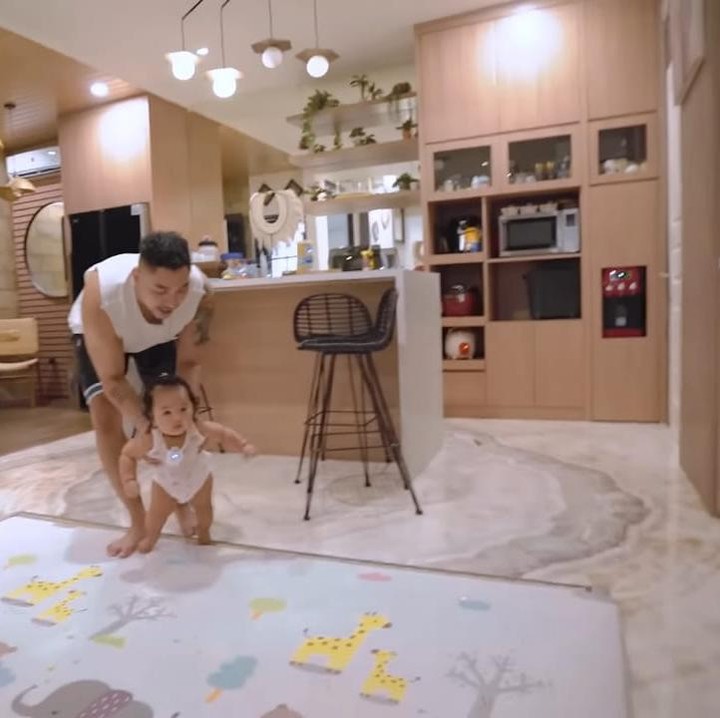 <p>Tidak hanya ruang tamu saja yang menggunakan warna <em>earth tone</em>, dapur pasangan yang satu ini juga menggunakannya. Siti dan Krisjiana memilih warna cokelat dan putih untuk mempercantik dapur mereka yang modern ini. (Foto: YouTube Sibad Krisjiana)</p>