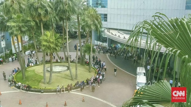 Sejumlah pekerja di Jakarta berhamburan keluar kantor saat merasakan gempa bumi, Kamis (8/12) pagi. Mereka menunggu beberapa menit sebelum masuk lagi ke gedung.