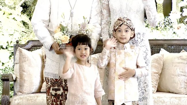 Jan Ethes menyapa hadirin dengan lambaian tangan 'dadah' dan nyengir usai menyerahkan cincin kawin ke Kaesang Pangarep.