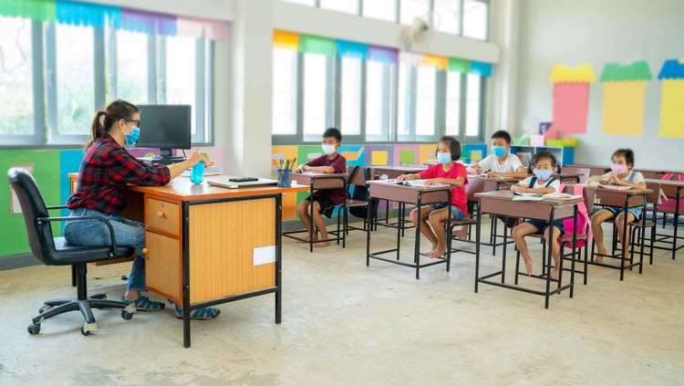 Group of school kids wearing protective mask to Protect Against Covid-19 with teacher sitting in classroom,education,elementary school,Social Distancing,learning and people concept.