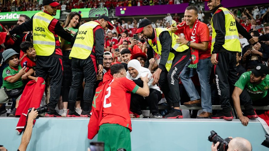 Morocco's defender #02 Achraf Hakimi (R) is greeted by his mother at the end of the Qatar 2022 World Cup Group F football match between Belgium and Morocco at the Al-Thumama Stadium in Doha on November 27, 2022. (Photo by Fadel Senna / AFP) (Photo by FADEL SENNA/AFP via Getty Images)