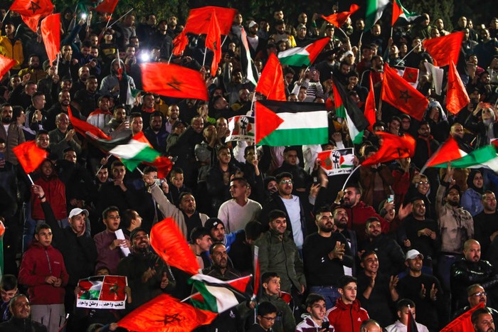 NABLUS, WEST BANK, PALESTINE - 2022/12/10: Palestinian supporters for Morocco's national football team celebrate in the occupied West Bank city of Nablus as they score the opening goal during the Qatar 2022 World Cup quarter-final football match between Morocco and Portugal. (Photo by Nasser Ishtayeh/SOPA Images/LightRocket via Getty Images)