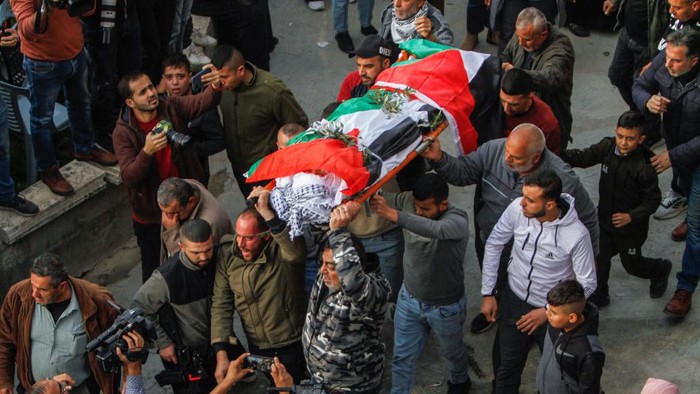 JENIN, WEST BANK, PALESTINE - 2022/12/12: (EDITOR'S NOTE : Image depicts death)
Mourners carry the body of 15-year-old Palestinian Jana Zakarneh in the city of Jenin in the occupied West Bank. Jana was shot dead by the Israeli army while she was on the roof of her house, during an army raid on the city. (Photo by Nasser Ishtayeh/SOPA Images/LightRocket via Getty Images)