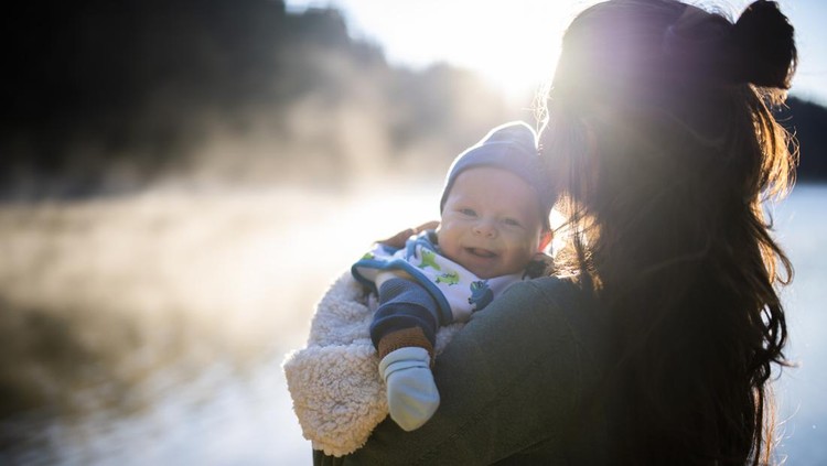 Mommy and happy little baby boy on mountain adventure.