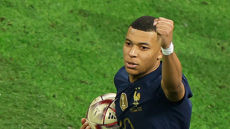 Kylian Mbappe France's forward #10 Kylian Mbappe celebrates scoring his team's first goal from the penalty spot during the Qatar 2022 World Cup football final match between Argentina and France at Lusail Stadium in Lusail, north of Doha on December 18, 2022. (Photo by Odd ANDERSEN / AFP) (Photo by ODD ANDERSEN/AFP via Getty Images)