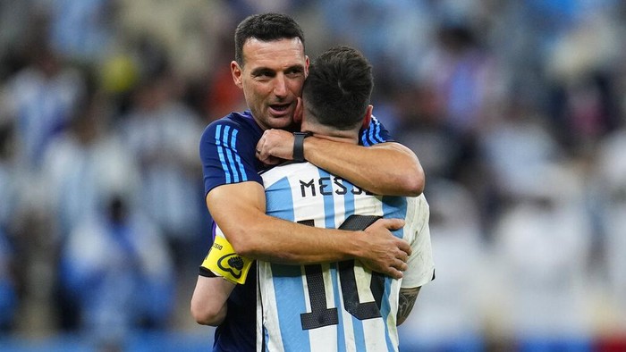 Argentina's head coach Lionel Scaloni embraces Argentina's Lionel Messi at the end of the World Cup quarterfinal soccer match between the Netherlands and Argentina, at the Lusail Stadium in Lusail, Qatar, Saturday, Dec. 10, 2022. (AP Photo/Natacha Pisarenko)