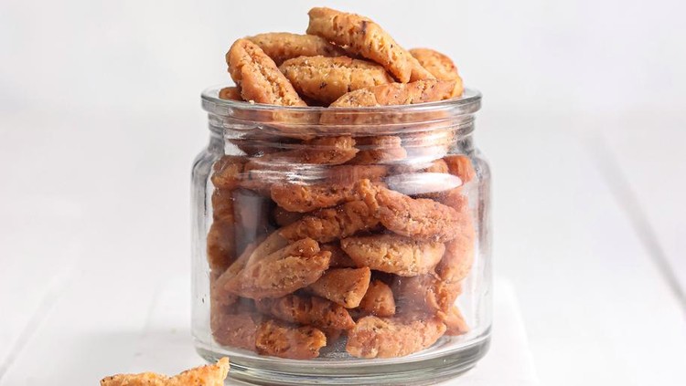 1413358140 Seed Ketapang (biji ketapang) is a traditional snack made from sago flour mixed with coconut milk and sugar. formed and fried. served in a jar with a bright background