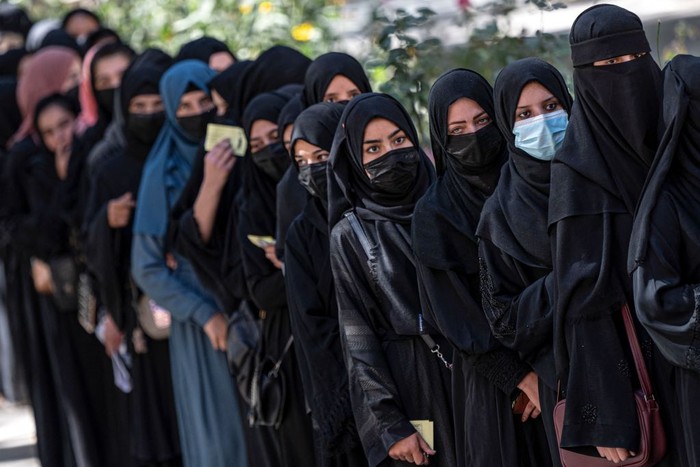 Afghan female students stand in a queue after they arrive for entrance exams at Kabul University in Kabul on October 13, 2022. (Photo by Wakil KOHSAR / AFP) (Photo by WAKIL KOHSAR/AFP via Getty Images)
