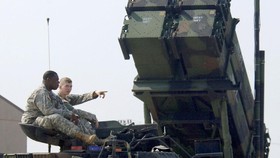 (FILES) This file photo taken on October 14, 2006 shows US soldiers sitting on a turret of the M2A2 Bradley Fighting Vehicle in front of the launcher of a Patriot missile PAC-3 system during Air Power Day at the US air base in Osan, south of Seoul. -