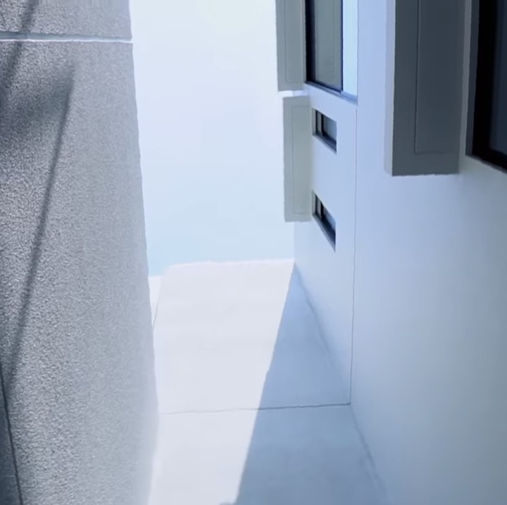 <p>Di sisi lain basement ada sebuah lahan terbuka dengan tembok yang menjulang tinggi. Ini menjadi sumber cahaya serta sirkulasi udara alami bagi seluruh rumah. Di lantai dua, bagian ini berbatasan langsung dengan keluarga yang dilengkapi kaca besar. Sayangnya, ruang tersebut dapat tereskspos dengan mudah dari rumah sebelah, sehingga Caca perlu meninggikan tembok yang tampak di sebelah kiri foto. (Foto: https://www.youtube.com/@CacaTengkerChannel)</p>