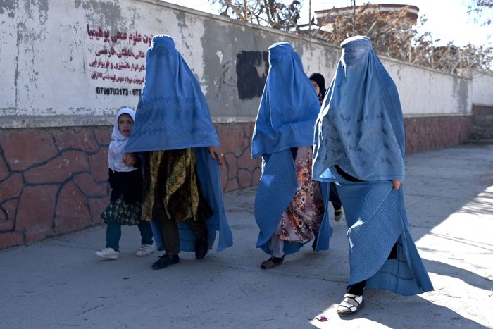 TOPSHOT - Afghan women walk a long a road in Ghazni Province on November 27, 2022. (Photo by Wakil kohsar / AFP) (Photo by WAKIL KOHSAR/AFP via Getty Images)
