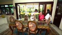 <p>Area meja makan dengan pintu kaca menghubungkan dalam rumah dengan halaman belakang. Meskipun meja makannya besar, penyanyi 47 tahun ini mengaku rumahnya hanya dihuni tiga orang. (Foto: YouTube/TRANS7 OFFICIAL)</p>