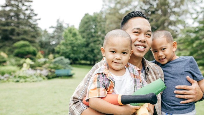 Happy family spending time with kids in the park