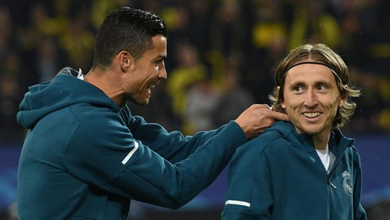 Real Madrid's forward from Portugal Cristiano Ronaldo (L) and Real Madrid's midfielder from Croatia Luka Modric joke around prior to the UEFA Champions League Group H football match BVB Borussia Dortmund v Real Madrid in Dortmund, western Germany on