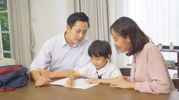 1405855218 Portrait of happy smiling Asian Family. A student studying homework from school at home or house in family relationship. Love of father, mother, and son. People lifestyle. Education activity.