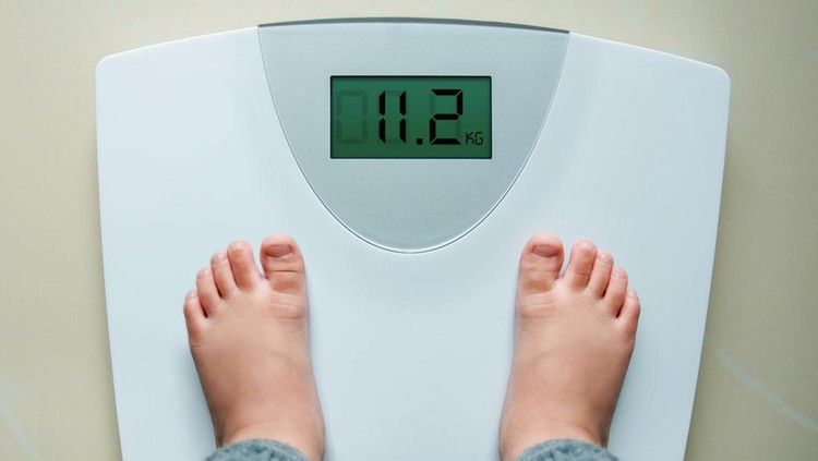 Healthy Weight Gain for Baby or Children Concept, A 2 Years Old Kid Standing on Weight Scales, Top View