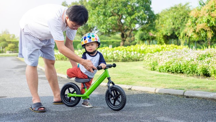 Young father spend time with Cute little Asian 18 months / 1 year old toddler boy child, Dad and son play and have fun with balance bike (run bike), Dad tech son to ride bike, father's day concept