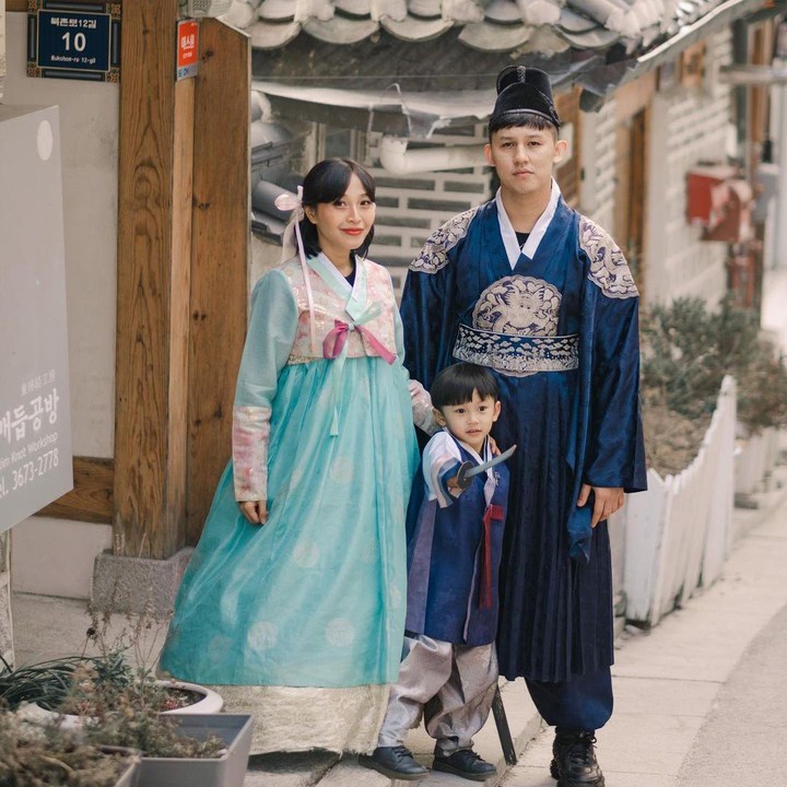 <p>Salah satu yang menarik perhatian adalah saat Rinni bersama suami dan anaknya datang ke Bukchon Hanok Village di Seoul. Ketiganya kompak mengenakan pakaian tradisional Korea, Hanbok. (Foto: Instagram @rinni_w)</p>