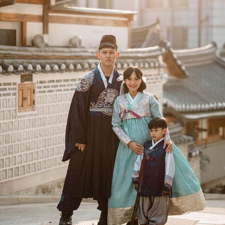 <p>Rini tampil cantik mengenakan Hanbok warna biru muda bernuansa pink dengan motif bunga. Sementara itu, suami dan anaknya mengenakan Hanbok pria berwarna biru tua. (Foto: Instagram @rinni_w)</p>
