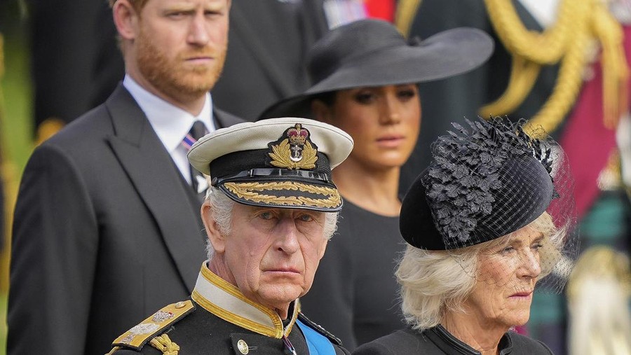 Britain's King Charles III, from bottom left, Camilla, the Queen Consort, Prince Harry and Meghan, Duchess of Sussex watch as the coffin of Queen Elizabeth II is placed into the hearse following the state funeral service in Westminster Abbey in central London Monday Sept. 19, 2022. The Queen, who died aged 96 on Sept. 8, will be buried at Windsor alongside her late husband, Prince Philip, who died last year. (AP Photo/Martin Meissner, Pool)