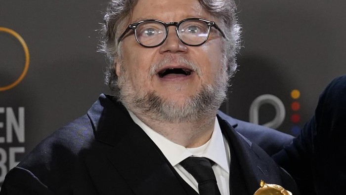Guillermo del Toro poses in the press room with the award for best motion picture, animated for 