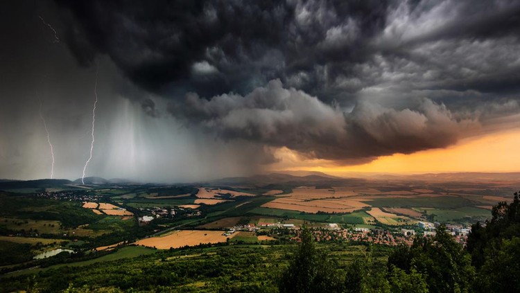 1263562386 A severe thunderstorm shelf cloud races across the country side on a summer afternoon