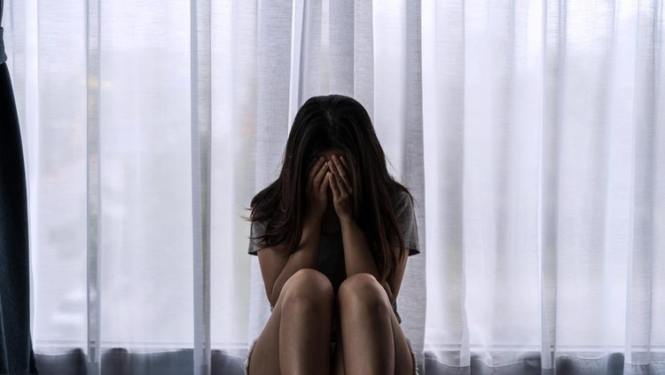 1397482187 Lonely young woman feeling depressed and stressed sitting in the dark bedroom, Negative emotion and mental health concept