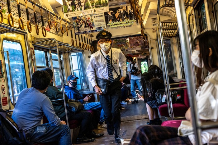 This picture taken on October 20, 2022 shows a train travelling through Choshi Electric Railway Line in Choshi, northeast Chiba prefecture. - In the driver's seat of a two-carriage train, Katsunori Takemoto puts on his white gloves and checks the antiquated gauges before setting out alongside cabbage fields in Japan's rural Chiba. Like many small railway lines across Japan's countryside, the 60-year-old trains that ply this route are a loss-maker, but Takemoto has found a way to keep the business afloat. - TO GO WITH Japan-transport-demographics-economy,FOCUS by Hiroshi HIYAMA (Photo by Philip FONG / AFP) / TO GO WITH Japan-transport-demographics-economy,FOCUS by Hiroshi HIYAMA (Photo by PHILIP FONG/AFP via Getty Images)