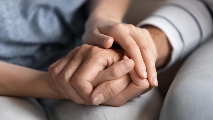 I know you can. Close up of millennial woman grown daughter, grandchild or younger friend holding tight hand of old mother, grandmother, elder relative or colleague helping to overpass life problems