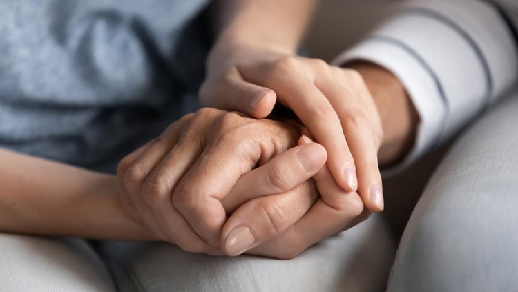 I know you can. Close up of millennial woman grown daughter, grandchild or younger friend holding tight hand of old mother, grandmother, elder relative or colleague helping to overpass life problems