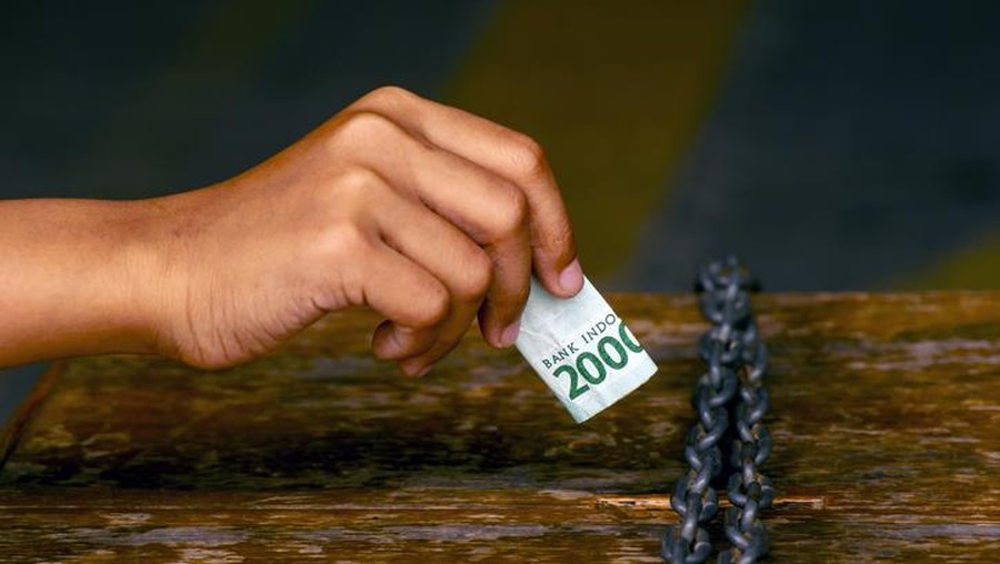 sedekah Infaq, an asian child hand put money in a charity box for donation