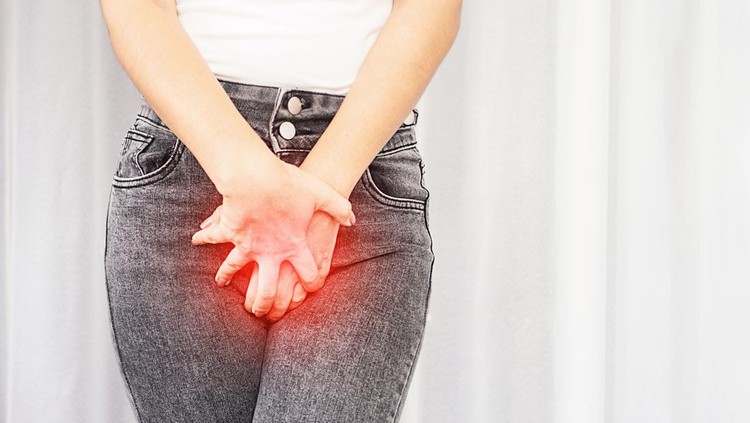 1317093185 closeup woman suffering from pain, itchy crotch hand holding her burning vaginal caused by bladder infections or cystitis