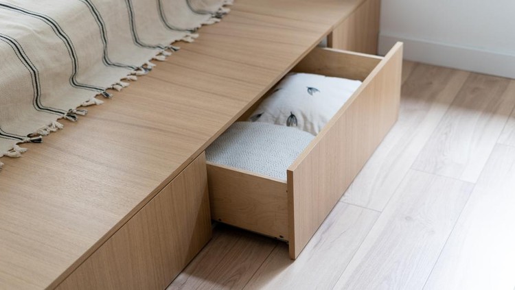 1335927279 Bedroom interior, wooden bed at modern room. Furniture design with open wood drawer, white pillow decoration object in box. Brown comfortable storage for bedding cushion.