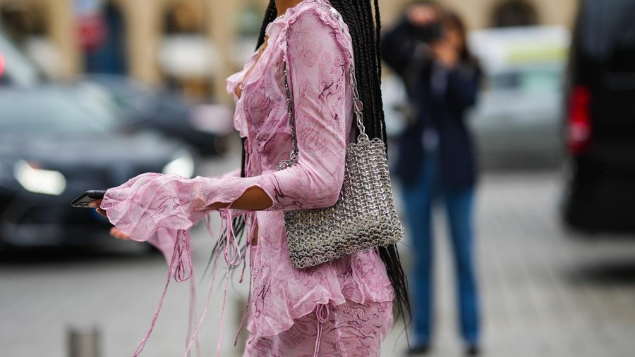 PARIS, FRANCE - OCTOBER 03: Xiayan wears a beige with pale yellow leopard print pattern high waist long skirt, a silver 1969 Nano metal-disc shoulder bag from Paco Rabanne, outside Zimmermann, Paris Fashion Week - Womenswear Spring/Summer 2023, on October 03, 2022 in Paris, France. (Photo by Edward Berthelot/Getty Images)